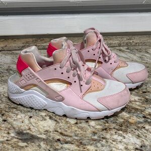 Woman’s Pink and White Nike Huarache